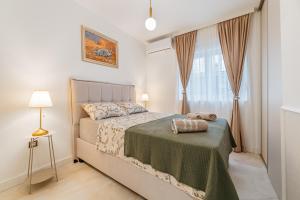 a bedroom with a bed and a window at Apartments TIME in Kotor