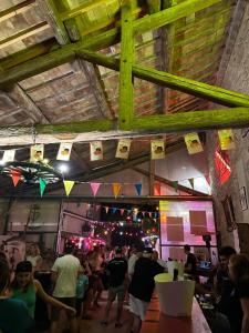 a crowd of people in a room with flags at Le Clos des Aramons in Bernis