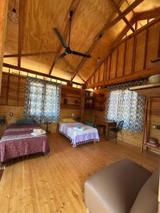 a large room with two beds and a table at KAO Cabin in Brisas de Zicatela