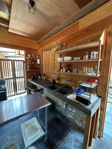 a kitchen with a sink and wooden walls at KAO Cabin in Brisas de Zicatela +5 photos