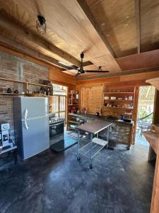 a kitchen with a refrigerator and a table in it at KAO Cabin in Brisas de Zicatela