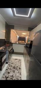 a large kitchen with a stove and a rug at شقة خاصة in Cairo