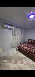 a bedroom with a bed and a window in a room at شقة خاصة in Cairo