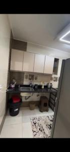 a kitchen with a sink and white cabinets at شقة خاصة in Cairo +2 photos