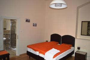 
a bedroom with a bed, table and a lamp at Valentina Apartments in Prague
