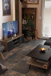 a living room with a television and a table at Galleria Home in Serres