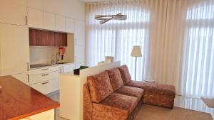 a living room with a couch and a kitchen at Cidadela do Viriato in Viseu +20 photos