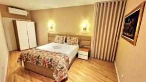a hotel room with a bed and a couch at Cidadela do Viriato in Viseu