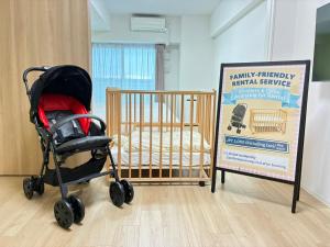 een kinderwagen naast een bord naast een wieg bij ESLEAD HOTEL Namba South Ⅲ in Osaka