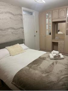a bedroom with a large bed with towels on it at Pats Place in Liverpool