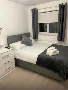a bedroom with a bed with two towels on it at Pats Place in Liverpool