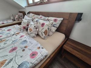 a bedroom with a bed with pillows on it at Chata Marta in Boží Dar +21 photos