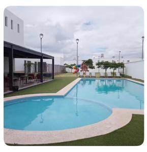 a large blue swimming pool in a building at Casa Completa Cómoda en el Sur in Santa Gertrudis