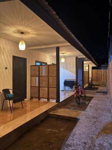 a room with a table and a bike on the floor at Gili Glow Homestay in Gili Trawangan +17 photos