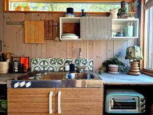 a kitchen with a sink and a counter top at FjordView Sanctuary in Nedstrand