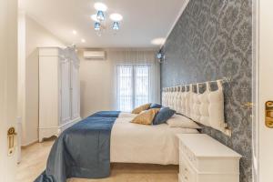 a bedroom with a large bed with a wall at Armea Suite Apartment in Trani
