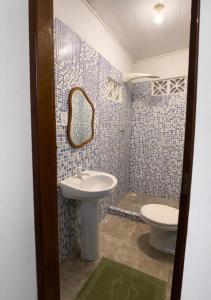 a bathroom with a sink and a toilet at Kalena Suítes in Lençóis +5 photos