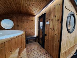 a bathroom with a tub in a wooden cabin at Camping Ushuaïa Villages Le Viaduc in Arlebosc +151 photos