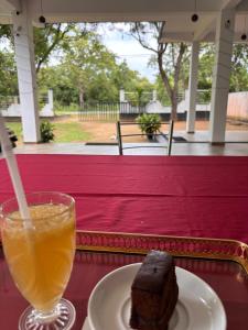 a piece of cake and a drink on a table at Jungle Lodge in Udawalawe +92 photos