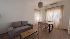 a living room with a couch and a table at Park Apartment - 2 Room APT in Lavradio