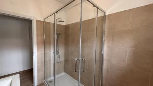 a shower with a glass door in a bathroom at Park Apartment - 2 Room APT in Lavradio +12 photos