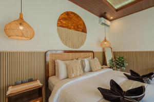 a bedroom with a large bed and pendant lights at Pondok loji villa in Ubud +11 photos
