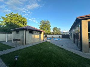 a backyard of a house with a grass yard at villacaptaingomi in Gomi