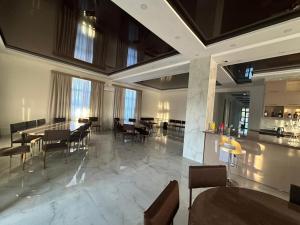 a dining room with tables and chairs in a building at villacaptaingomi in Gomi