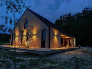 a small house with a large porch on aestead at Radawa LOVE in Radawa