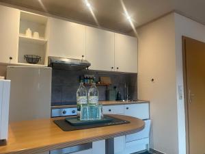 a kitchen with a counter with two bottles on it at Ferienwohnung Rhöner Luft in Bad Brückenau