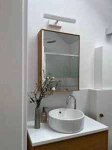 a bathroom with a white sink and a mirror at Nature Home Rybical in Rybical +65 photos