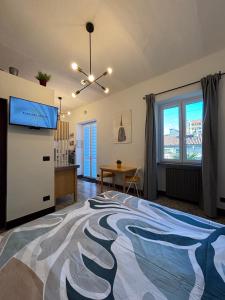 a bedroom with a large bed and a television at Fandara Suites in Turin