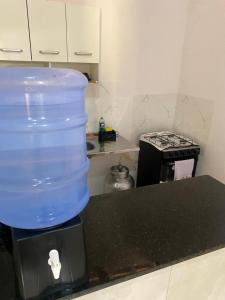 a large plastic container sitting on top of a kitchen counter at BARRA NOVA CASCAVEL CEARÁ-Casa Solaris in Cascavel