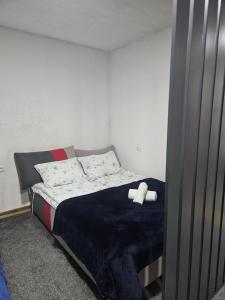 a bedroom with a bed with a white object on it at Apartmani Planinsko srce Vlašić in Vlasic