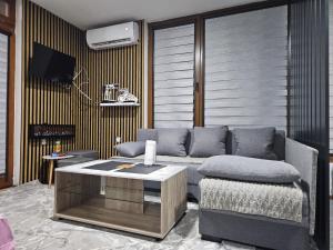 a living room with a couch and a table at Apartmani Planinsko srce Vlašić in Vlasic
