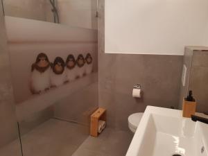 a bathroom with a toilet and a sink and a counter at Ferienwohnung Schwalbennest in Hopfgarten im Brixental