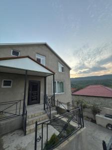 a house with a staircase leading to a door at Villa Qecres in Küpçal