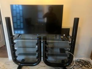 a large flat screen tv sitting on top of a stand at Oryx guest house in Oakdale