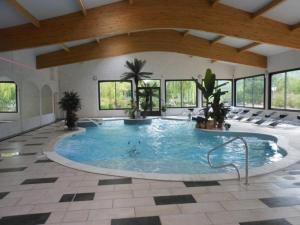 een groot zwembad in een grote kamer met ramen bij Locations LAC VERDON Climatisation in Les Salles-sur-Verdon