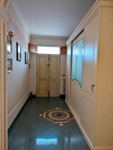 a hallway with two doors and a tile floor at Davids Home in San Vito dei Normanni +4 photos
