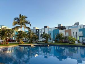 a large swimming pool in front of a city at Tu hogar en acapulco in General Juan N Alvarez International Airport
