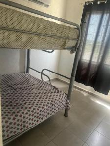 a bunk bed in a room with a window at Tu hogar en acapulco in General Juan N Alvarez International Airport