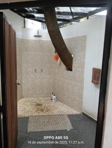 a bathroom with a shower with a tiled wall at Casa ixcanul in Montitlán