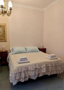 a bedroom with a bed with towels on it at Davids Home in San Vito dei Normanni