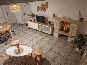 an overhead view of a living room with a fireplace at Cocooning in Cerences