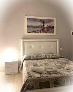 a bedroom with a bed with a picture on the wall at Marselo B&B in Bari