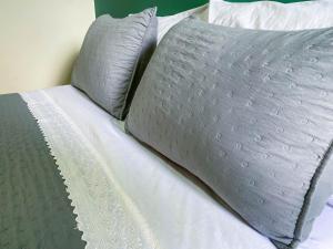 a bed with two pillows on top of it at Flat Morada da Neblina! in Chapada dos Guimarães