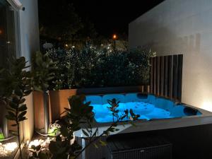 a jacuzzi tub on a balcony at night at Fijogo Villa - Seixas in Caminha