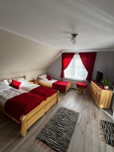 a bedroom with two beds and a window at Spokój u Zosi in Stare Bystre