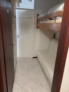 a small room with a bunk bed and a closet at Résidence MAYA in Saint-Lary-Soulan